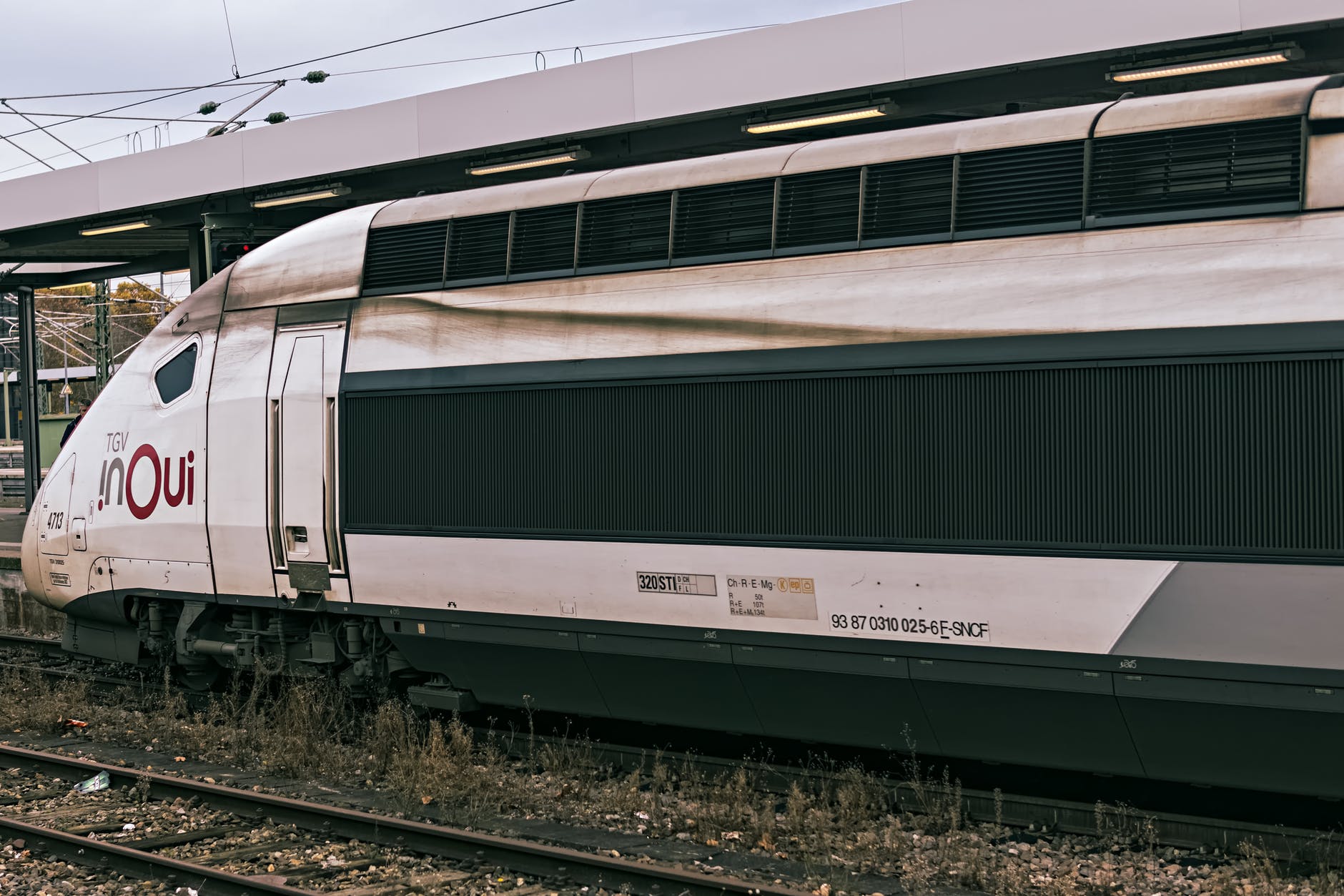 white and brown train on rail tracks