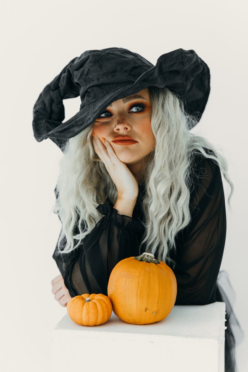 woman in witch costume feeling bored